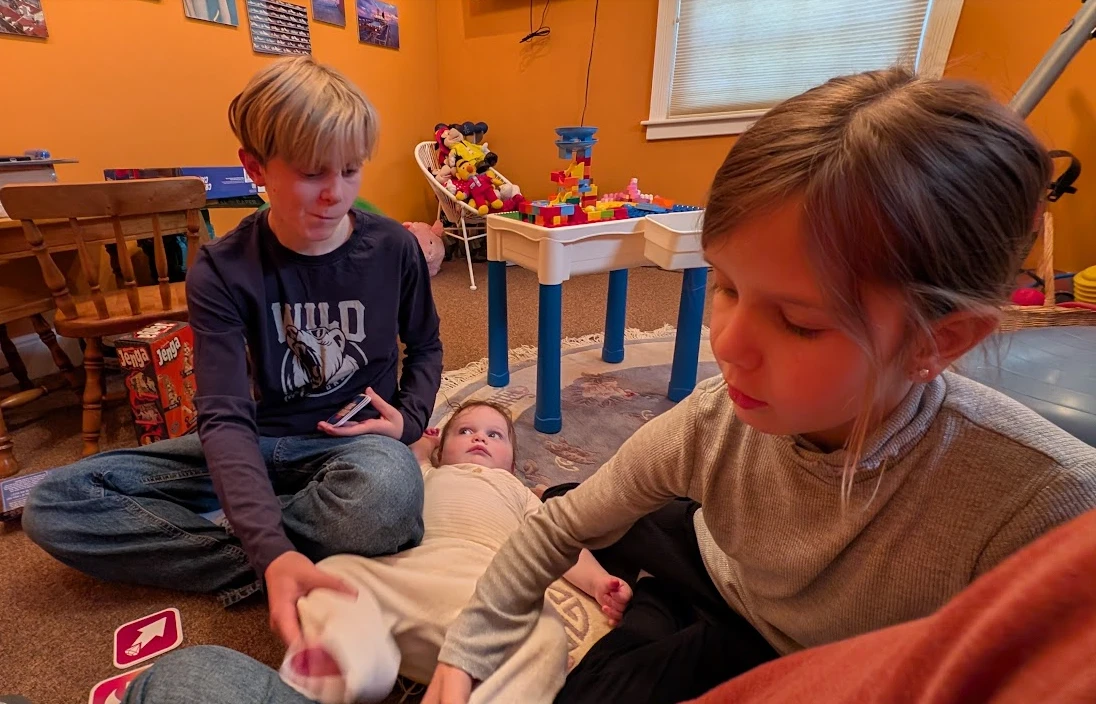 Michael's grandchildren playing together on the playroom floor
